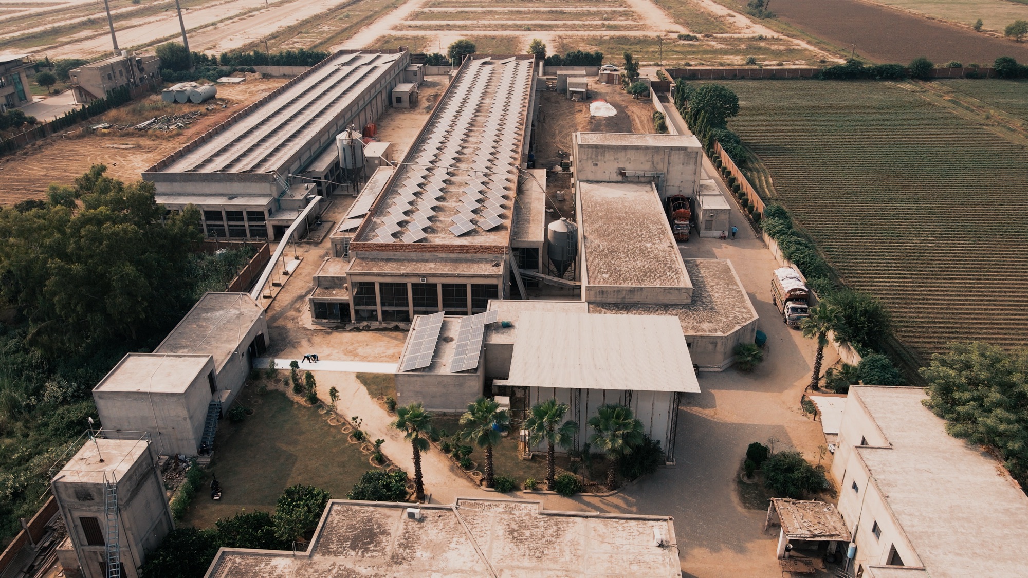 Wide aerial view of the full Al Barakah Foods facility and surrounding fields