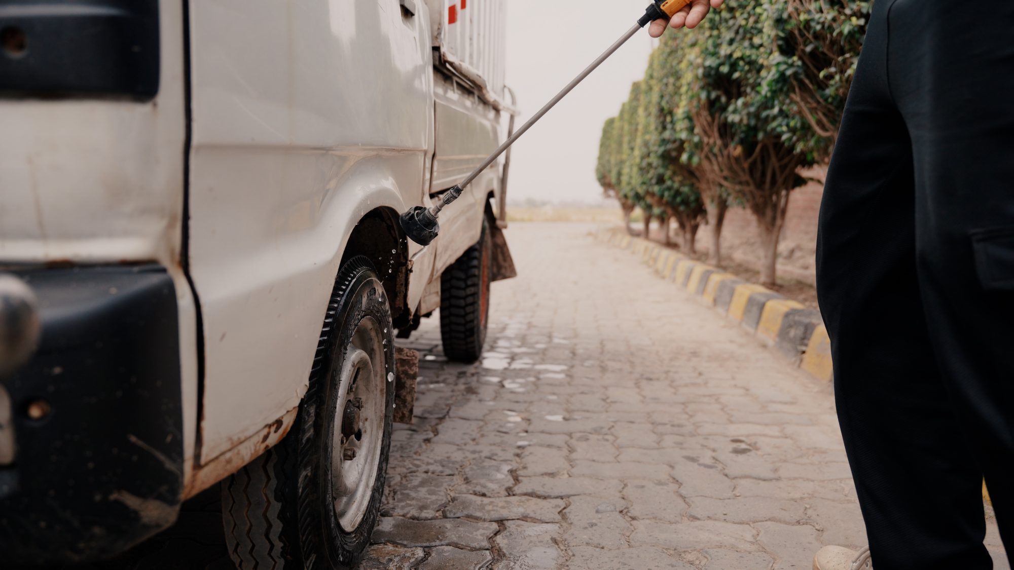 Disinfecting a delivery vehicle at the farm entrance