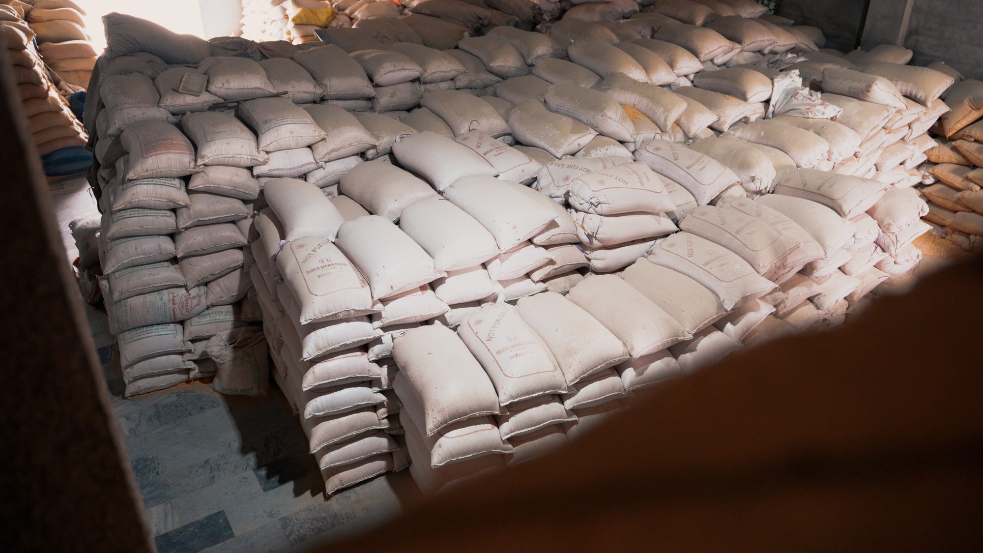 Stacked feed sacks in storage